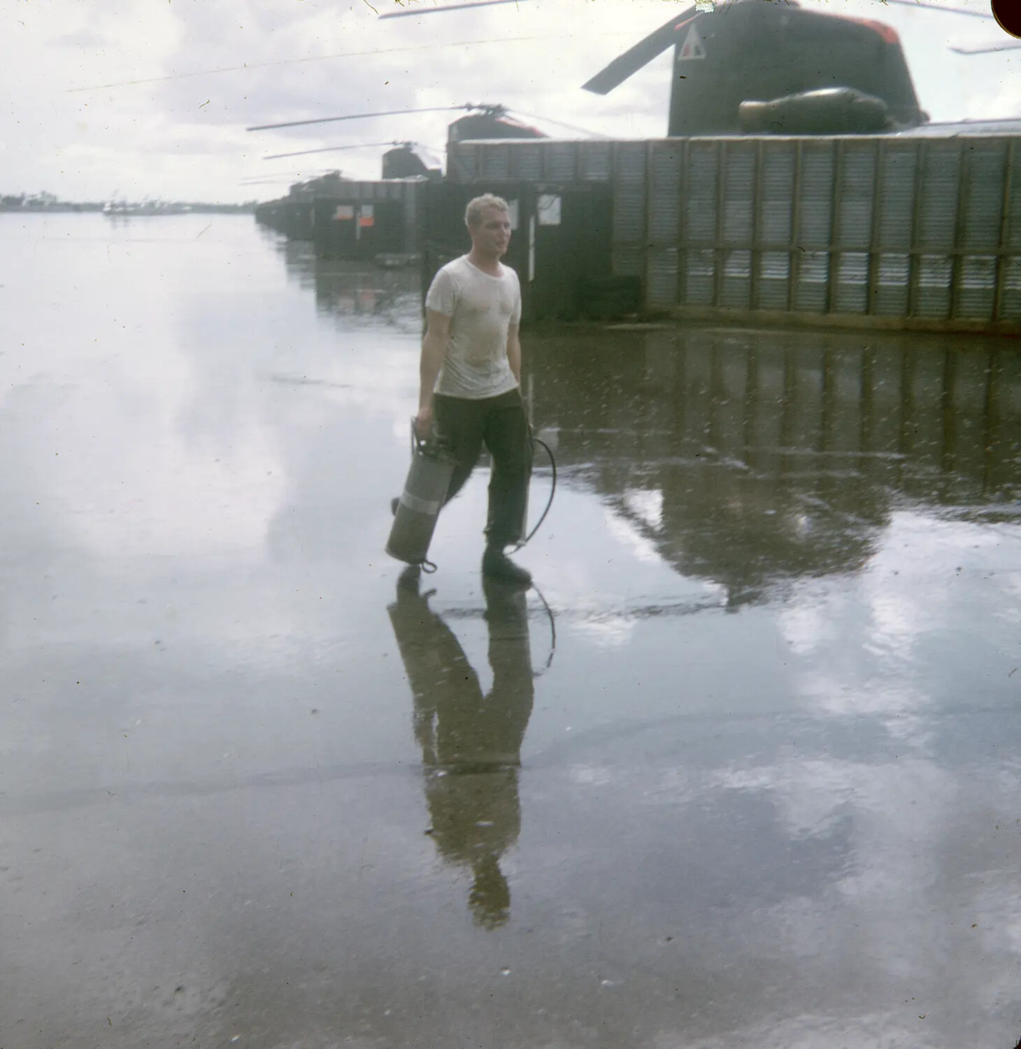 Serviceman Carrying Equipment Past Parked CH-47 Chinooks, Vietnam, Color Slide