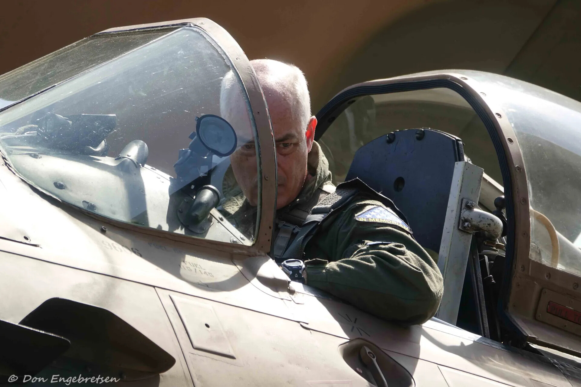 Veteran Aviator Seated in Skyraider-Type Cockpit at Reunion Event