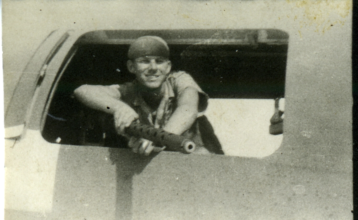 Serviceman Posing with a Submachine Gun in a Truck Window, Pacific Theater, WWII Era
