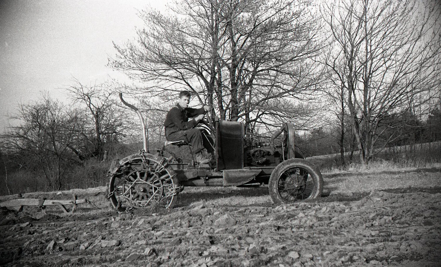 Close View of Farmer Driving Vintage Steel-Wheeled Tractor, New England Farm