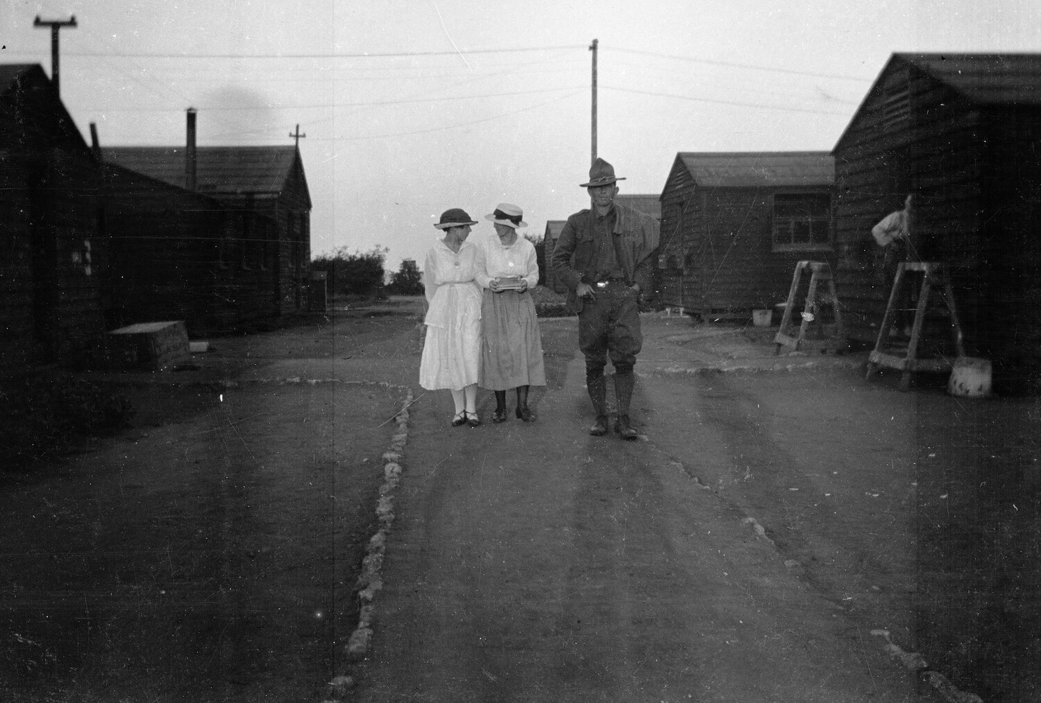 American Soldier and Civilian Women Walking Through Camp Row, World War I