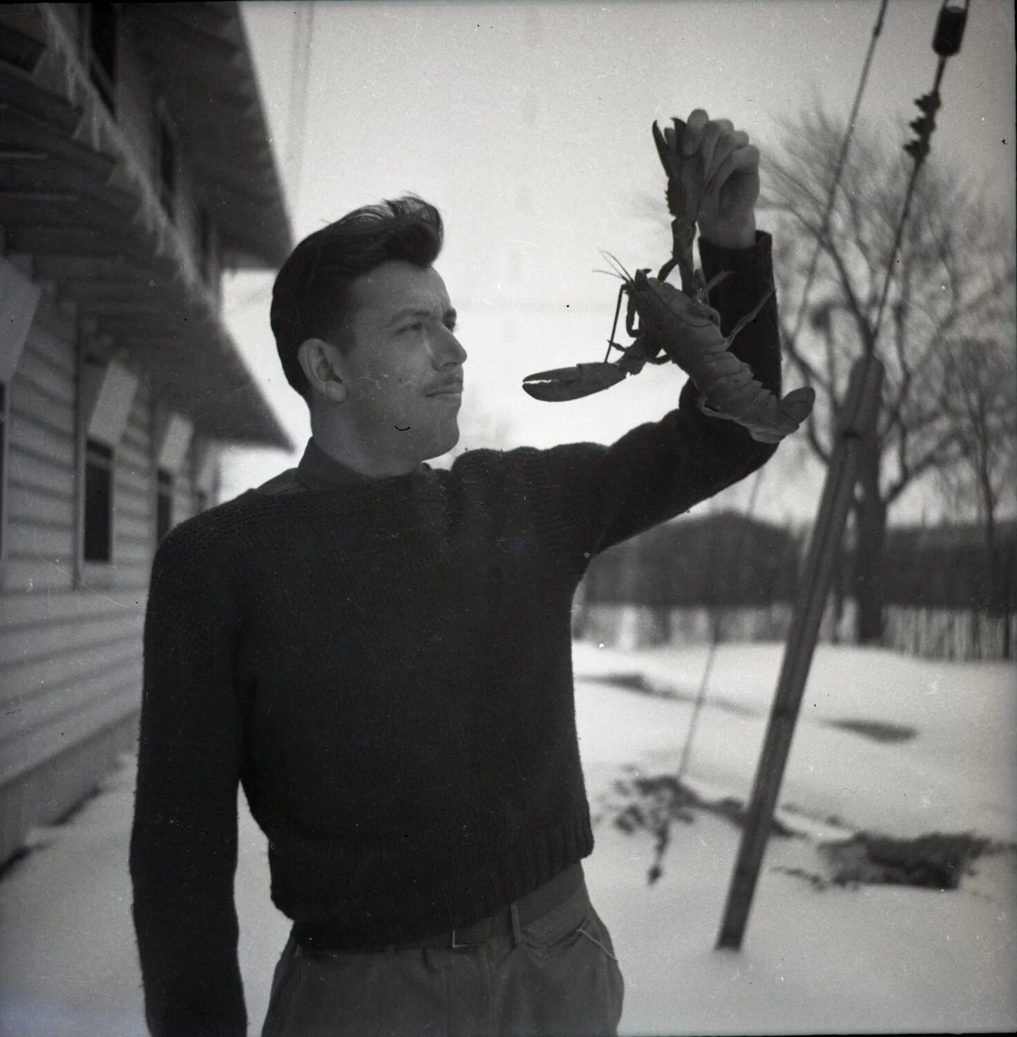Man Holding a Lobster in a Snowy Yard (Misfiled Personal Snapshot)