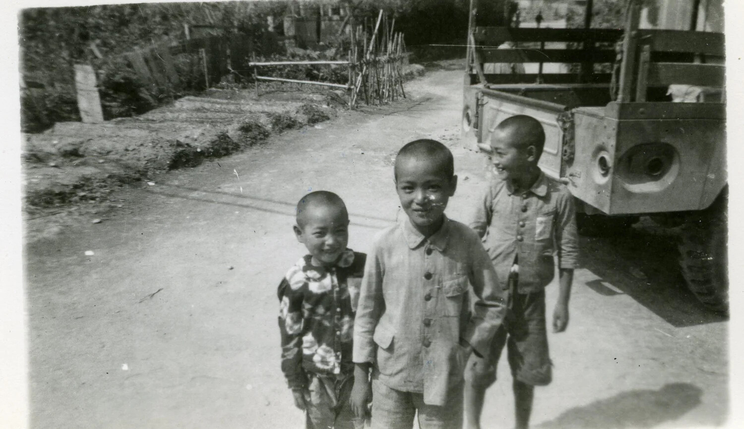 Three Japanese Boys Beside a Military Truck, Occupied Japan