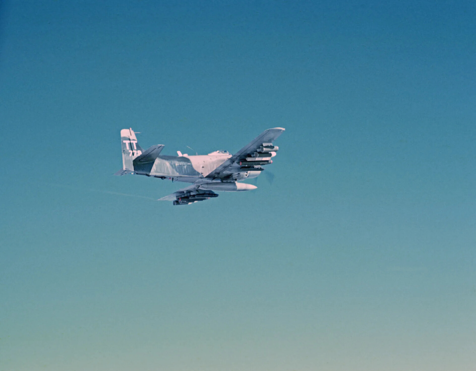 Douglas A-1 Skyraider "TT-779" in Banking Turn, Clear Sky, Southeast Asia, circa January 1970
