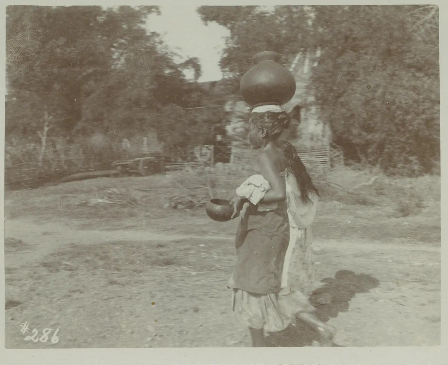 Woman Carrying Water Jar on Head Along Rural Path, Philippines, c. 1890s-1900s