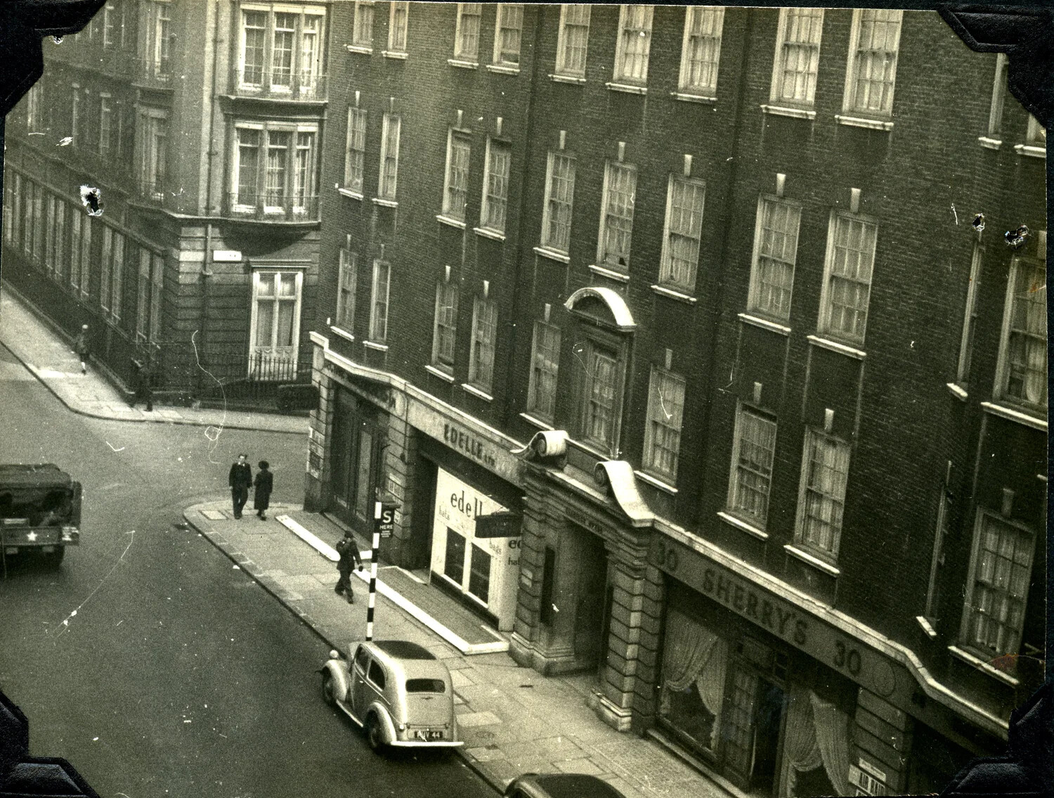 London Street Corner with U.S. Army Truck and 'Edell' Storefront, WWII Era (Jervey Signal Corps Album)