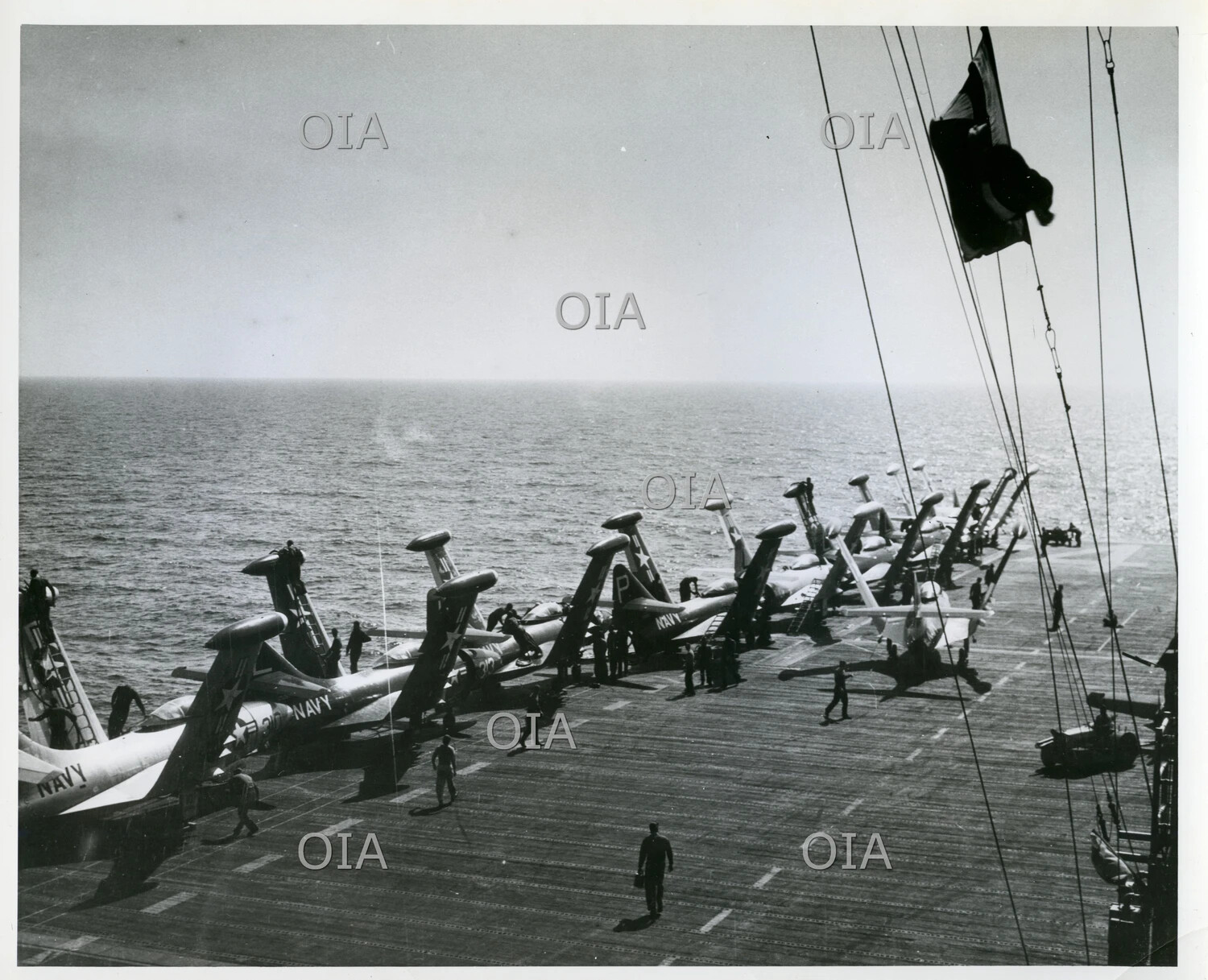 Row of Folded-Wing U.S. Navy Jet Aircraft Parked on Aircraft Carrier Flight Deck
