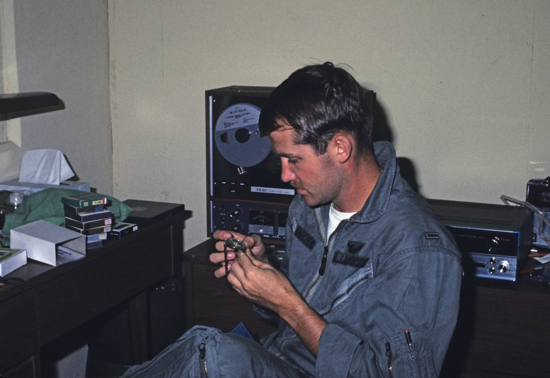 Airman in Flight Suit Examining a Wristwatch in Personal Quarters