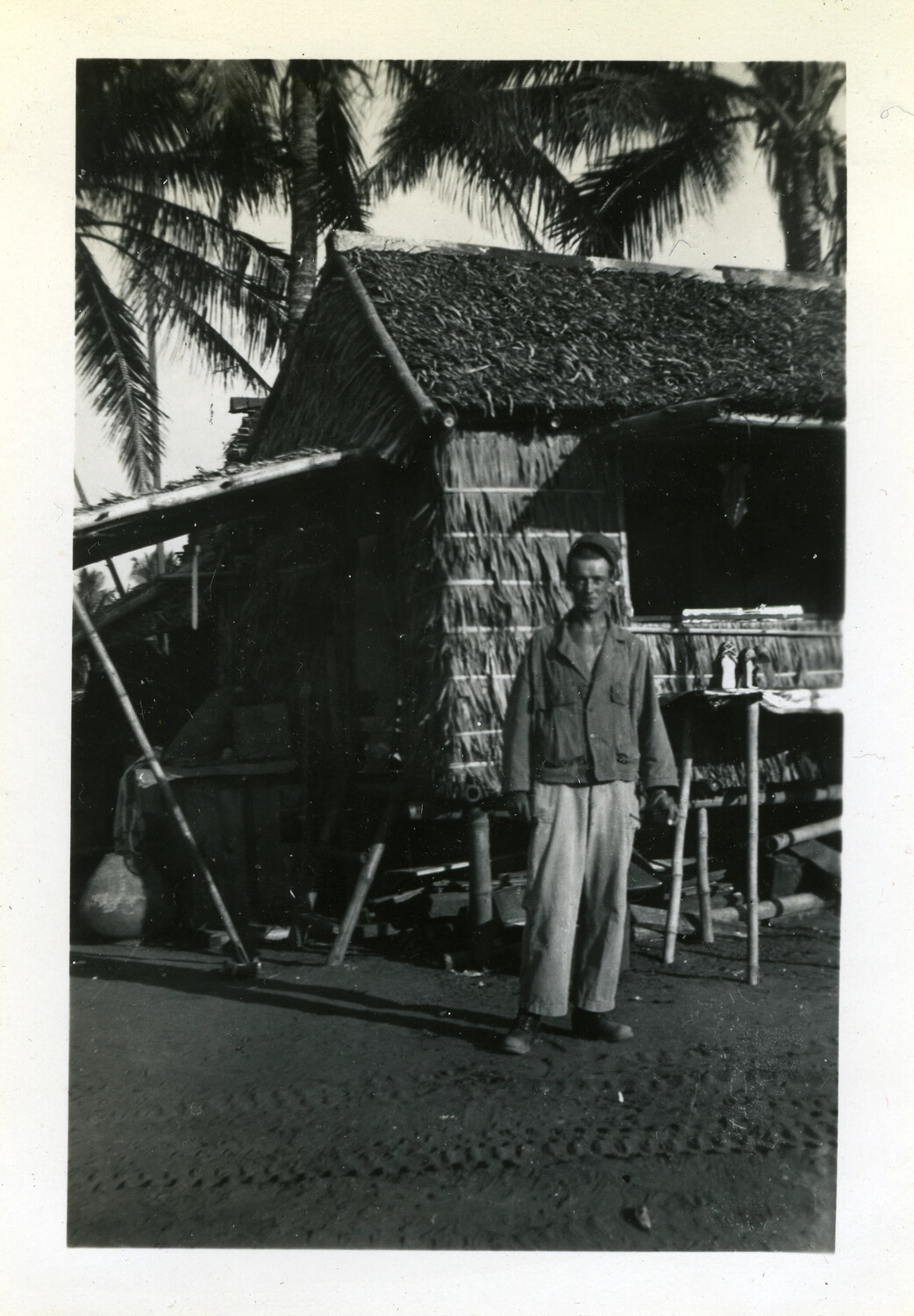 American Serviceman Beside Thatched-Roof Hut, Pacific Theater, WWII