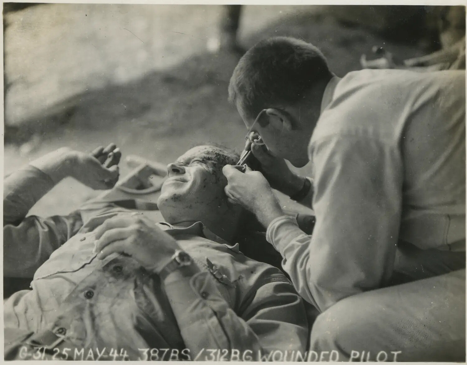 Wounded Pilot of the 387th Bomb Squadron, 312th Bomb Group, Receiving Treatment, 25 May 1944