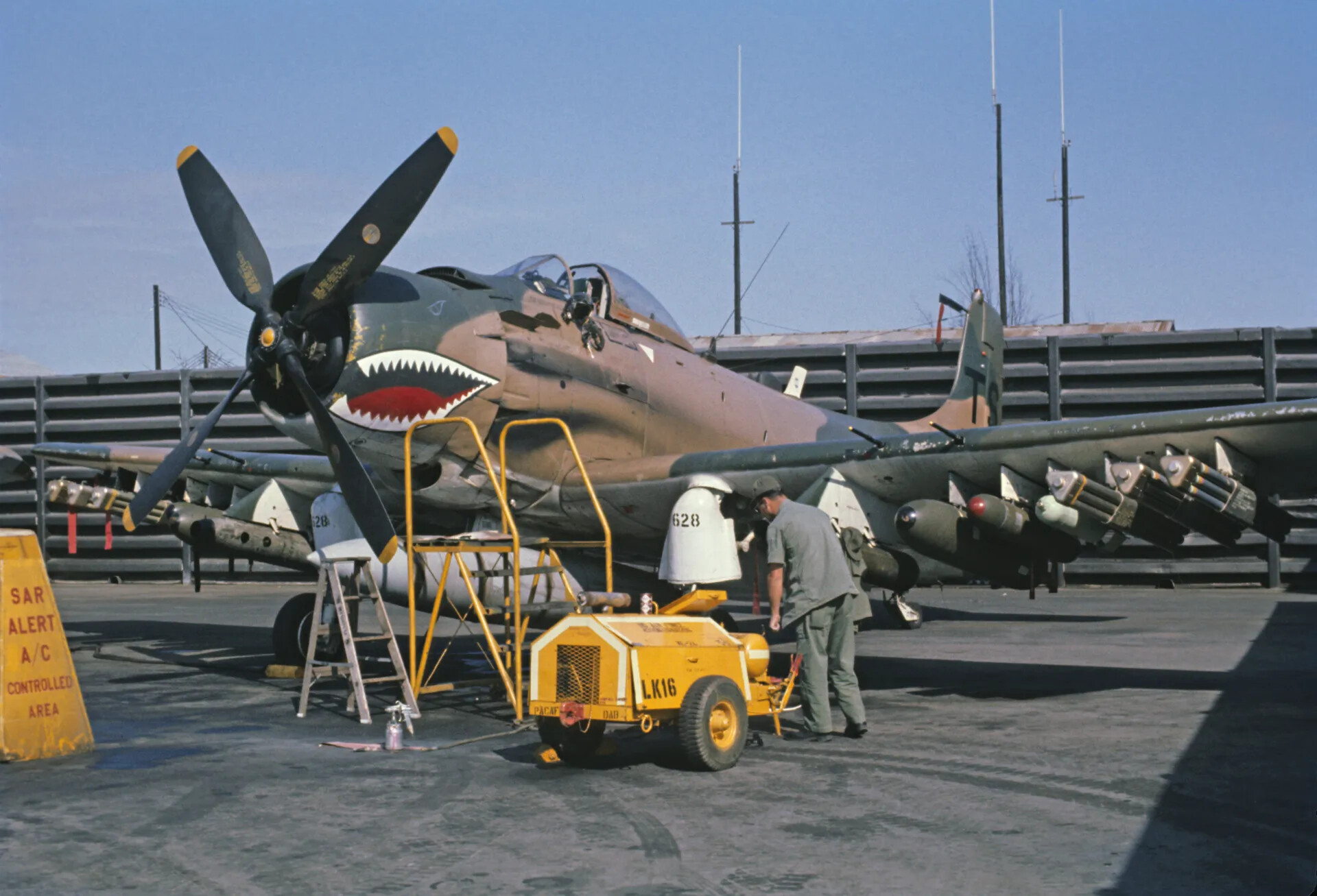 A-1 Skyraider 'SAR Alert' Aircraft No. 628 with Shark-Mouth Nose Art on Flight Line, Vietnam War Era