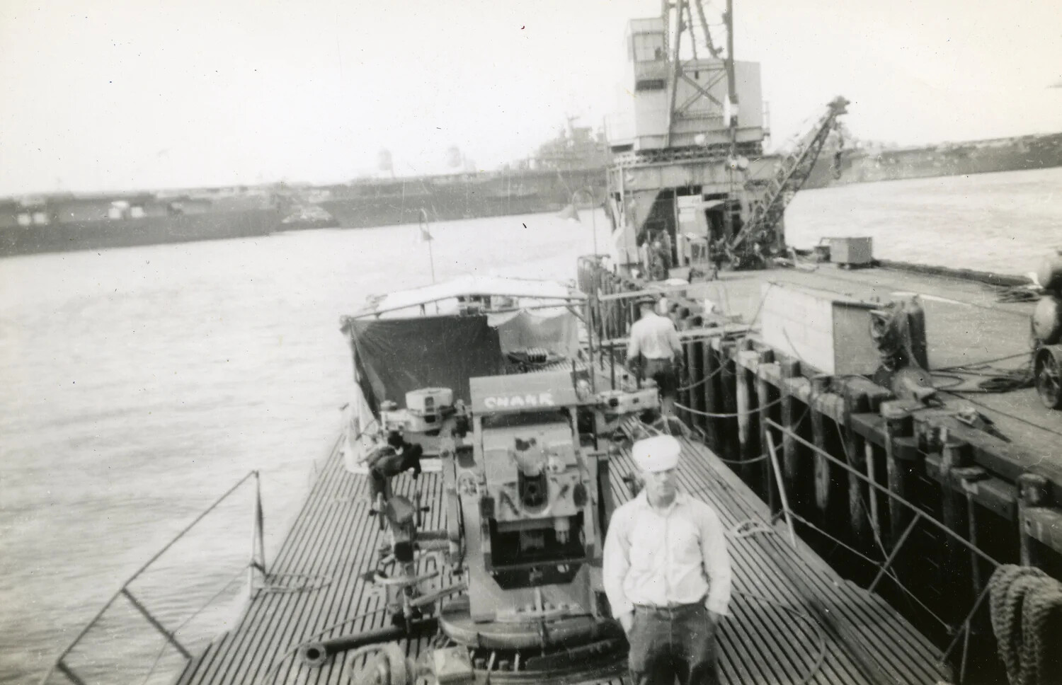 Sailor on the Deck of USS Charr (SS-328) Alongside a Repair Pier