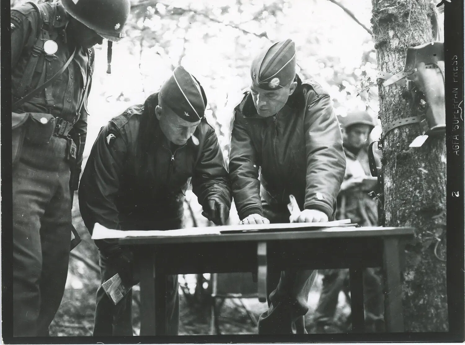 U.S. Army General Consulting Map with Staff Officer in Field, Likely Bastogne Area, December 1944