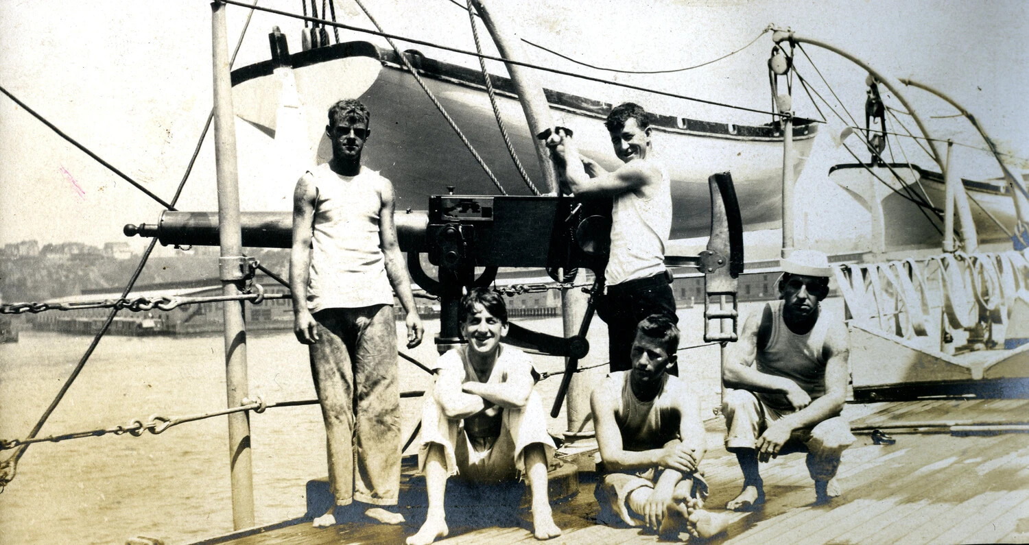 Sailors Posing with Deck-Mounted Machine Gun Aboard USS Columbia