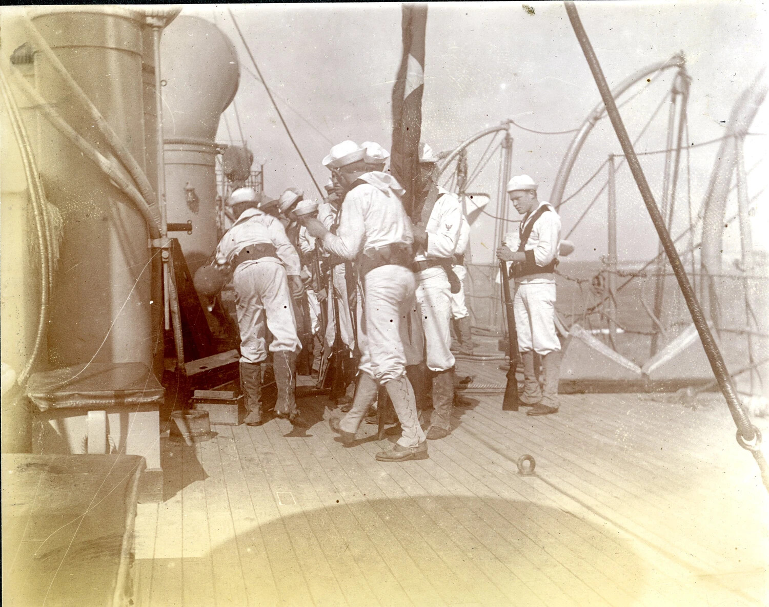 Sailors Mustered for Small-Arms Drill on Deck, Torpedo Net Rigged Out, USS Columbia, c. 1900s