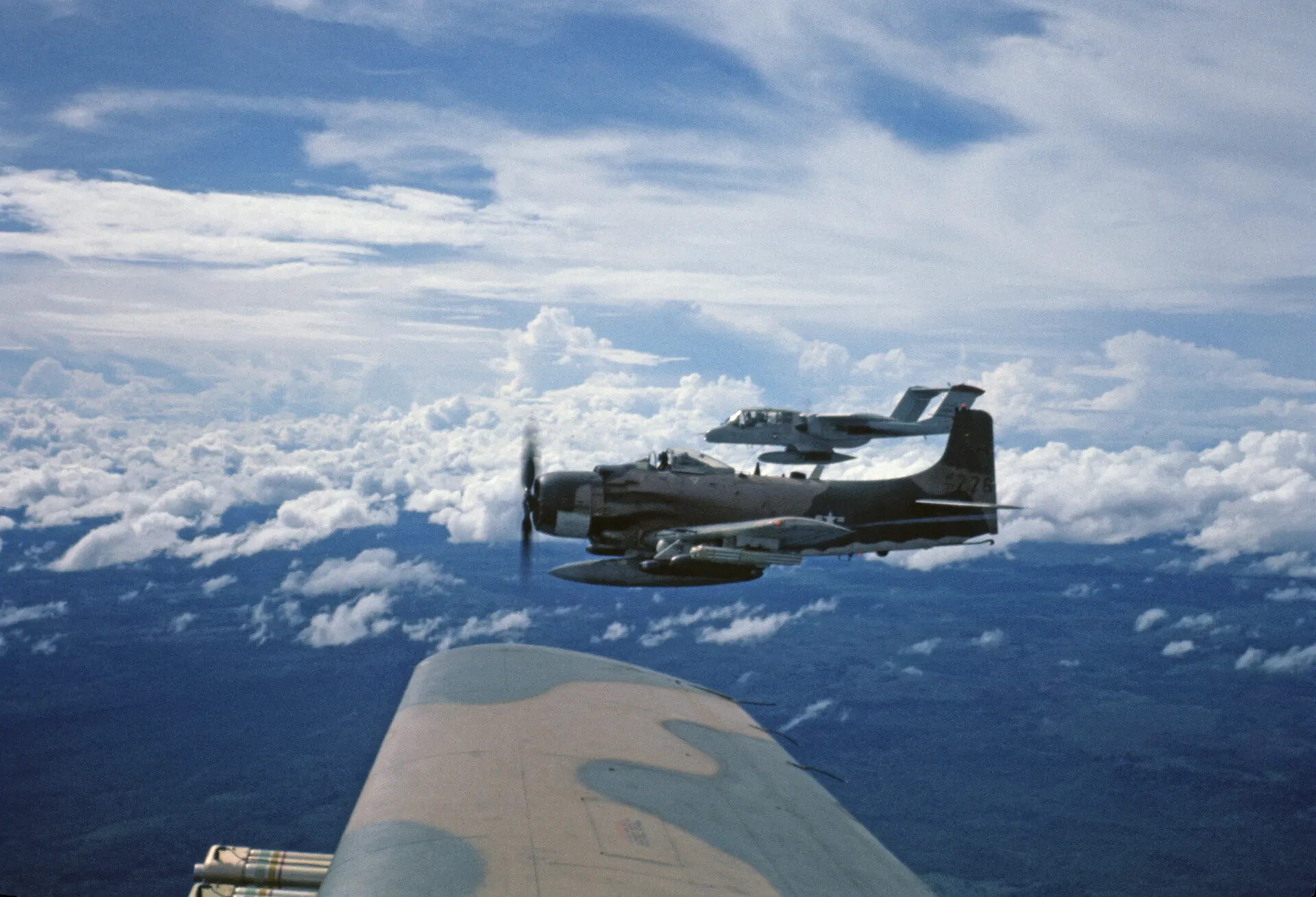 A-1 Skyraider and OV-10 Bronco in Formation Above Clouds, Air-to-Air View