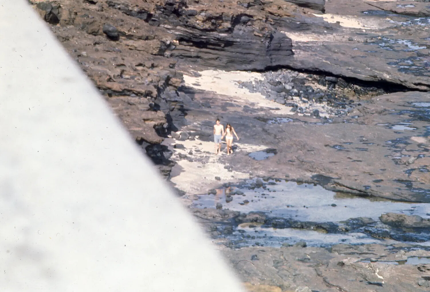 Couple Walking on a Volcanic Rock Beach, Liberty Port Snapshot (Ticonderoga Collection)