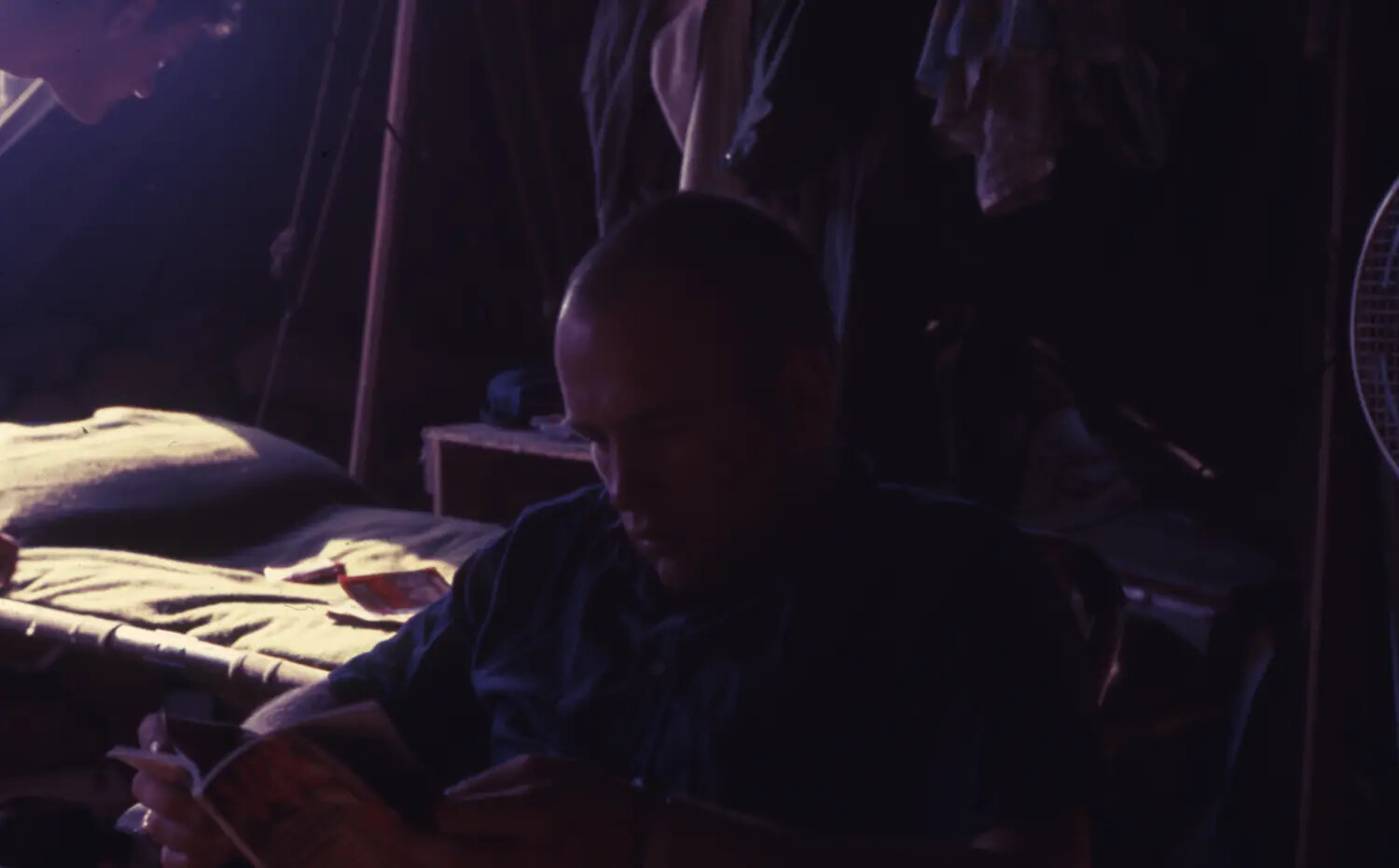 American Serviceman Reading in Barracks, Vietnam War Era (Cam Ranh Bay Area)