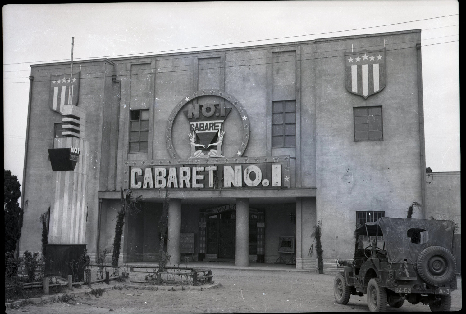 Exterior of 'Cabaret No. 1' Entertainment Venue with U.S. Military Jeep, WWII Era