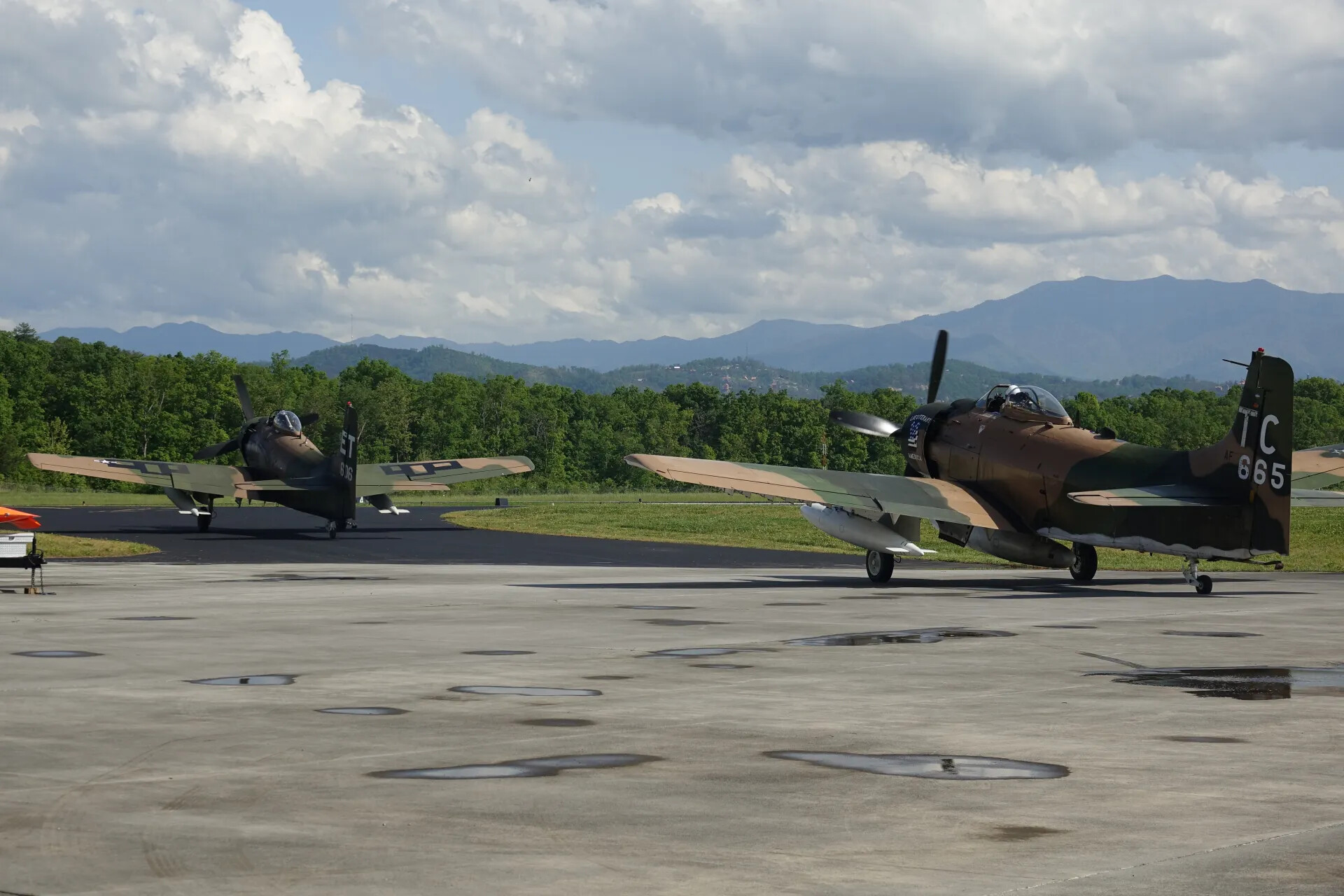Two A-1 Skyraiders Taxiing with Smoky Mountains Backdrop, Tail Codes TC 665 and ET 836