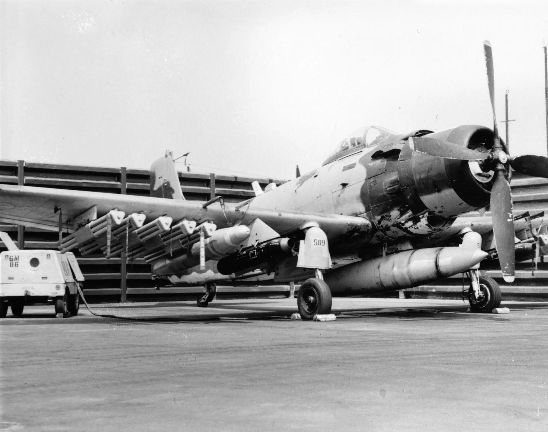 Weathered A-1 Skyraider "589" on Flight Line with Ground Power Unit, Vietnam War Era