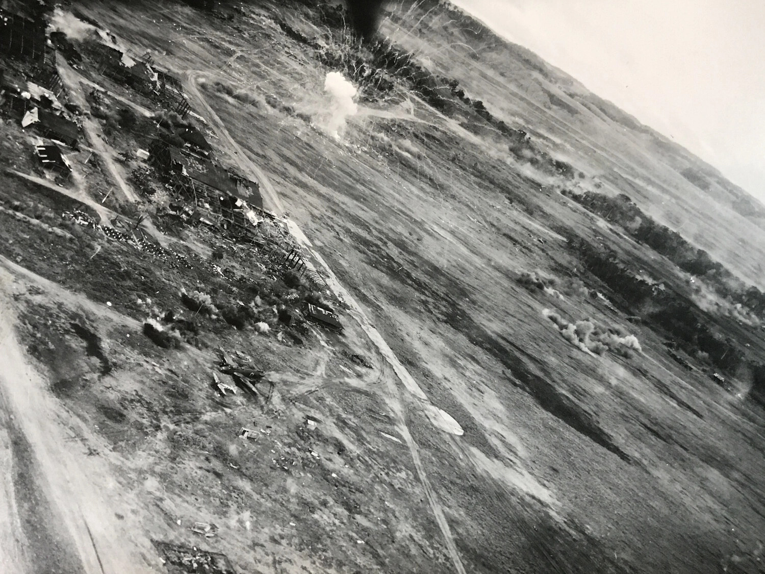 Bomb Detonation Over Japanese Airfield Facility During Low-Level Strike