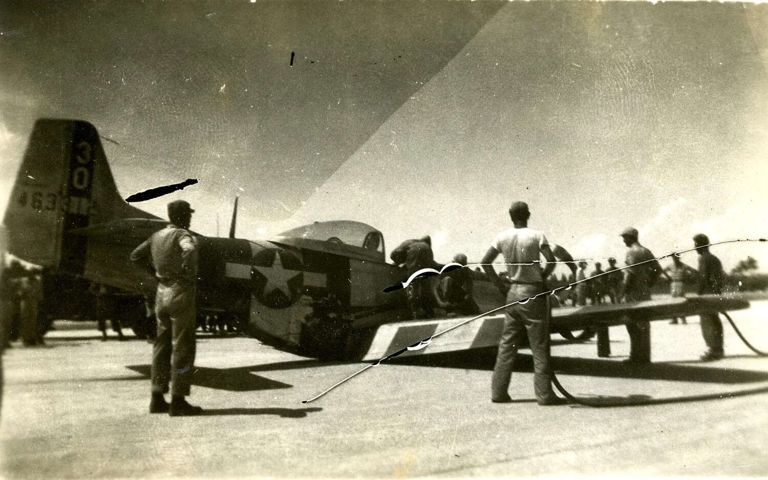 Single-Engine U.S. Fighter Aircraft (P-47 Thunderbolt type) Undergoing Ground Servicing, Ie Shima Airfield, 1945