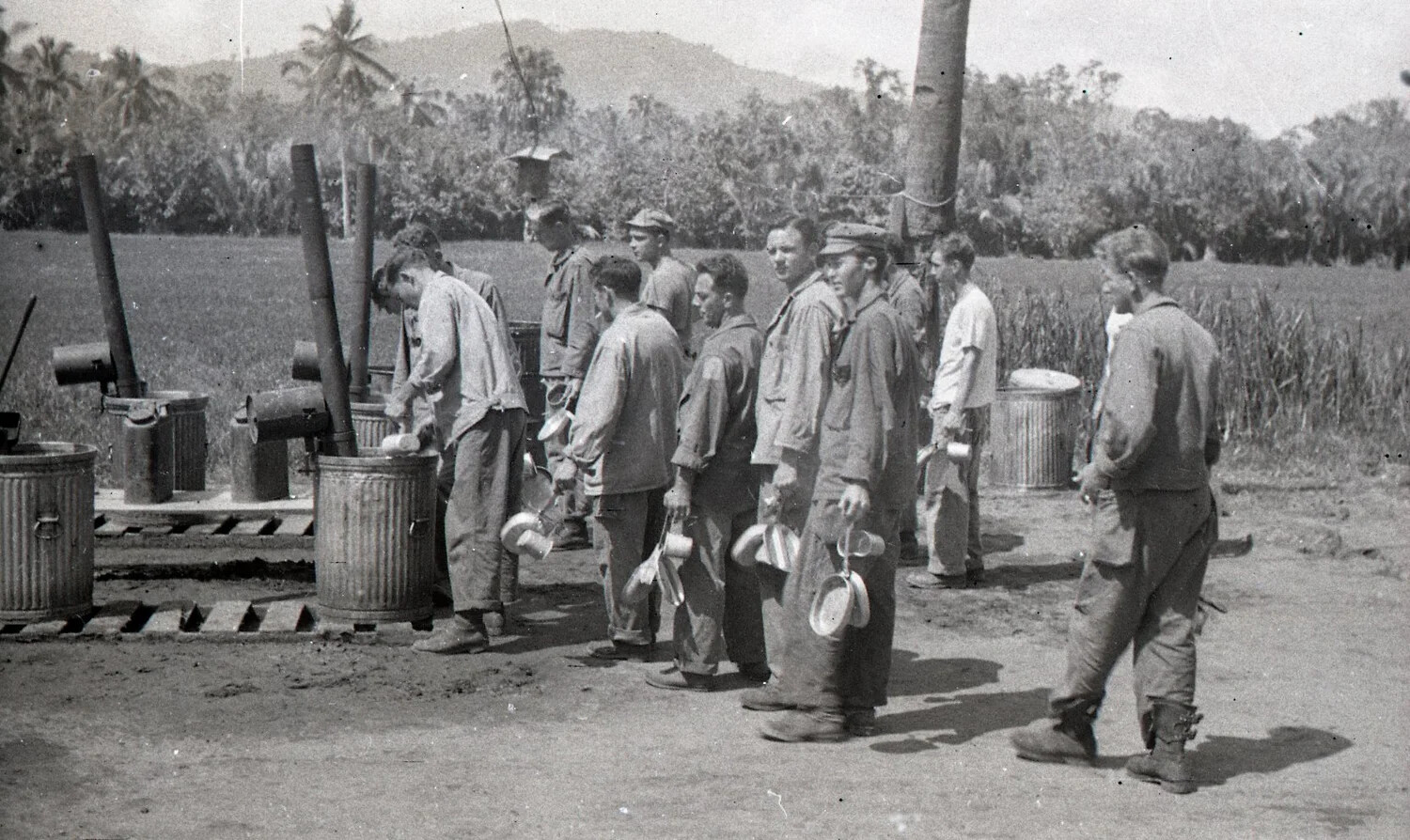 Soldiers Queuing at a Field Mess-Kit Washing Station, Luzon, Philippines, WWII