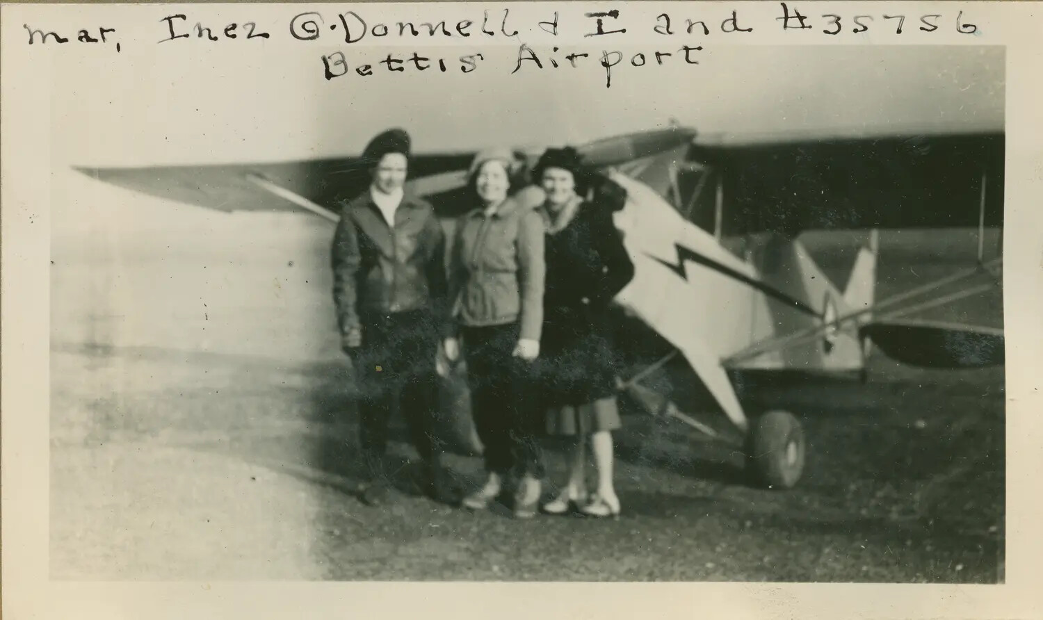 Three Women Beside a Biplane Marked 'NC35756,' Bettis Airport, c. early-to-mid 1930s