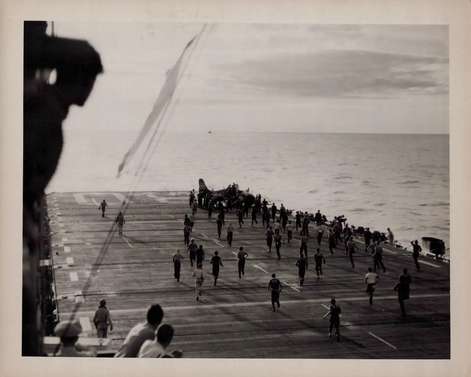 Flight Deck Crew Rushing to Aircraft Crash at the Bow, U.S. Navy Escort Carrier, WWII Era