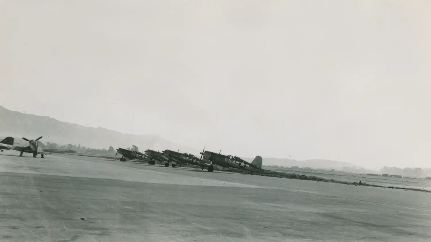 Line of Vought F4U Corsair Fighters Staged for Takeoff at a Korean War-Era Airfield