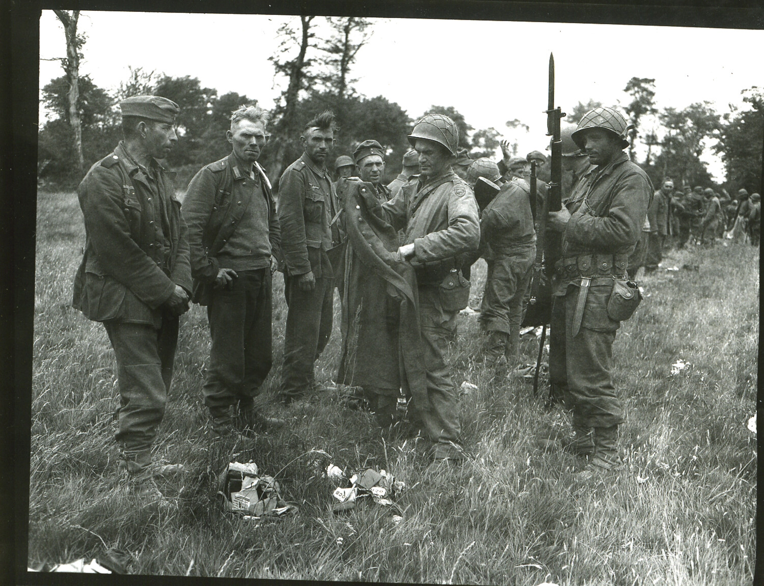 American Soldiers Searching German Prisoners of War in a Field, Normandy Campaign, 1944