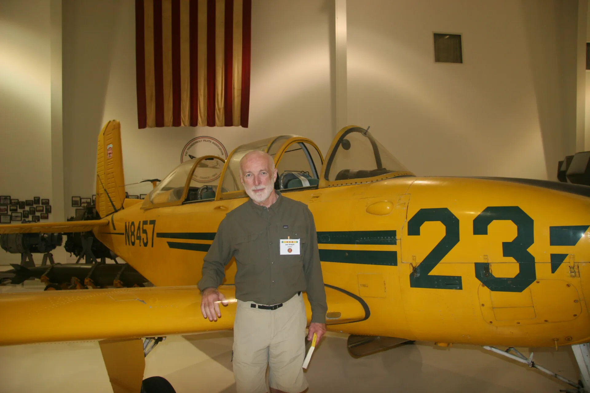 Veteran Posing with Vintage Training Aircraft at Aviation Museum, 2016