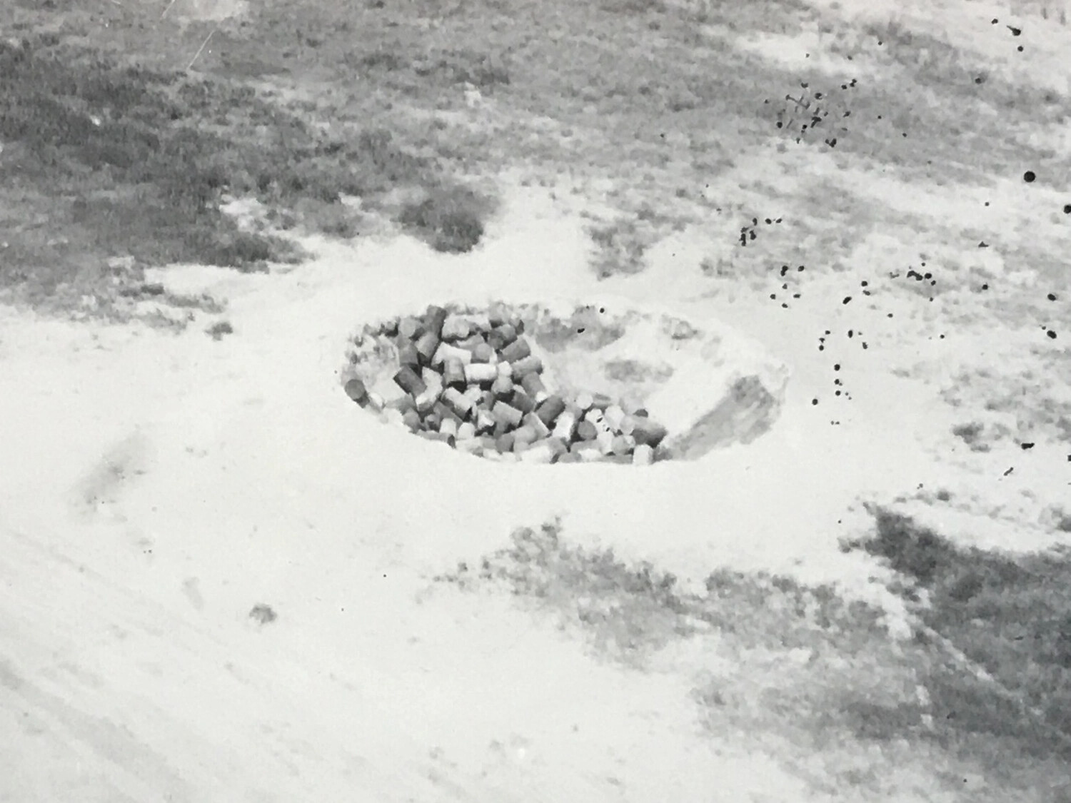 Aerial Detail Photograph - Bomb Crater with Crib/Block Fill on Airstrip Surface