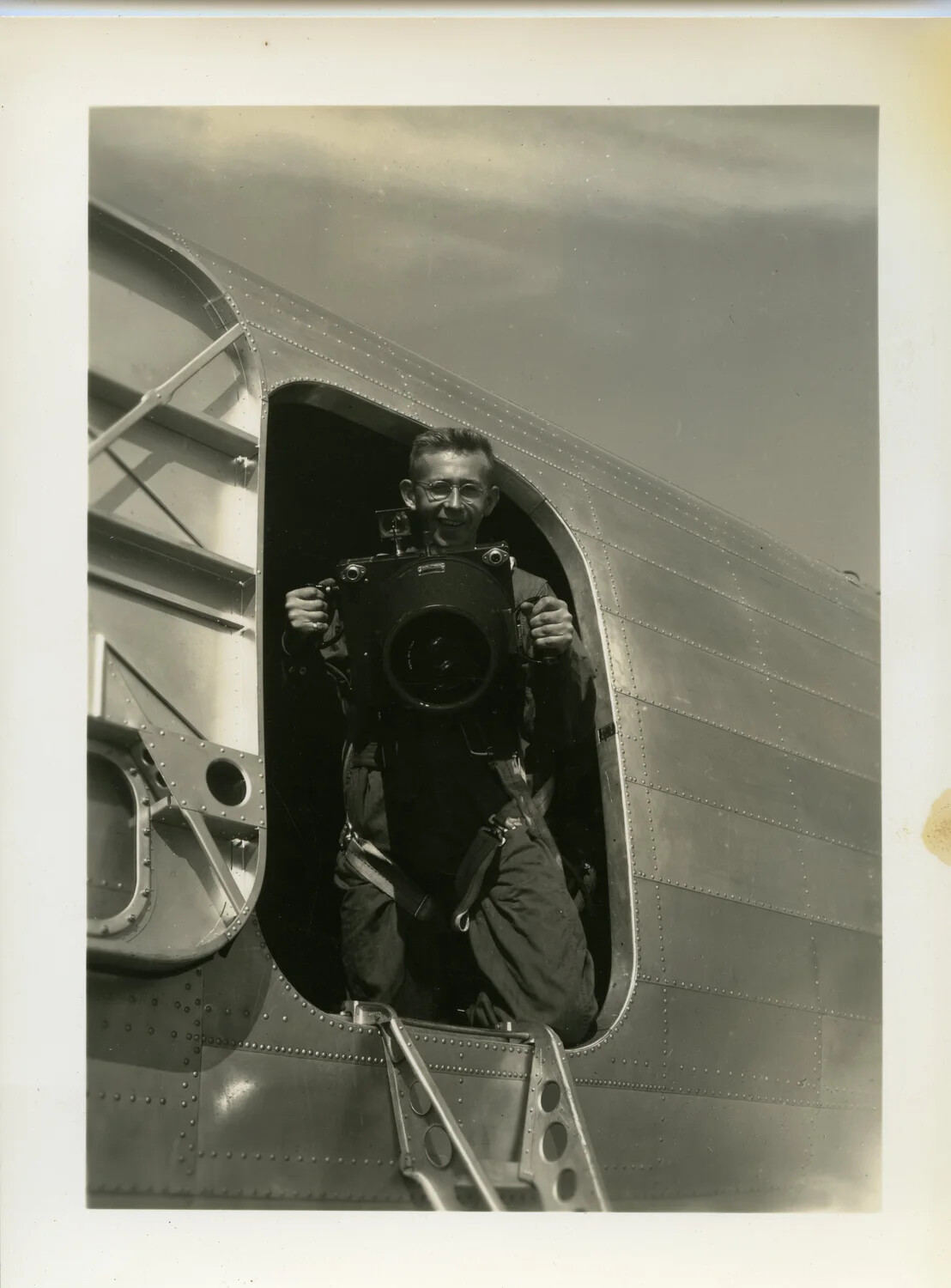 Airman Demonstrating Handheld Aerial Reconnaissance Camera in Aircraft Fuselage Hatch, WWII China-Burma Theater