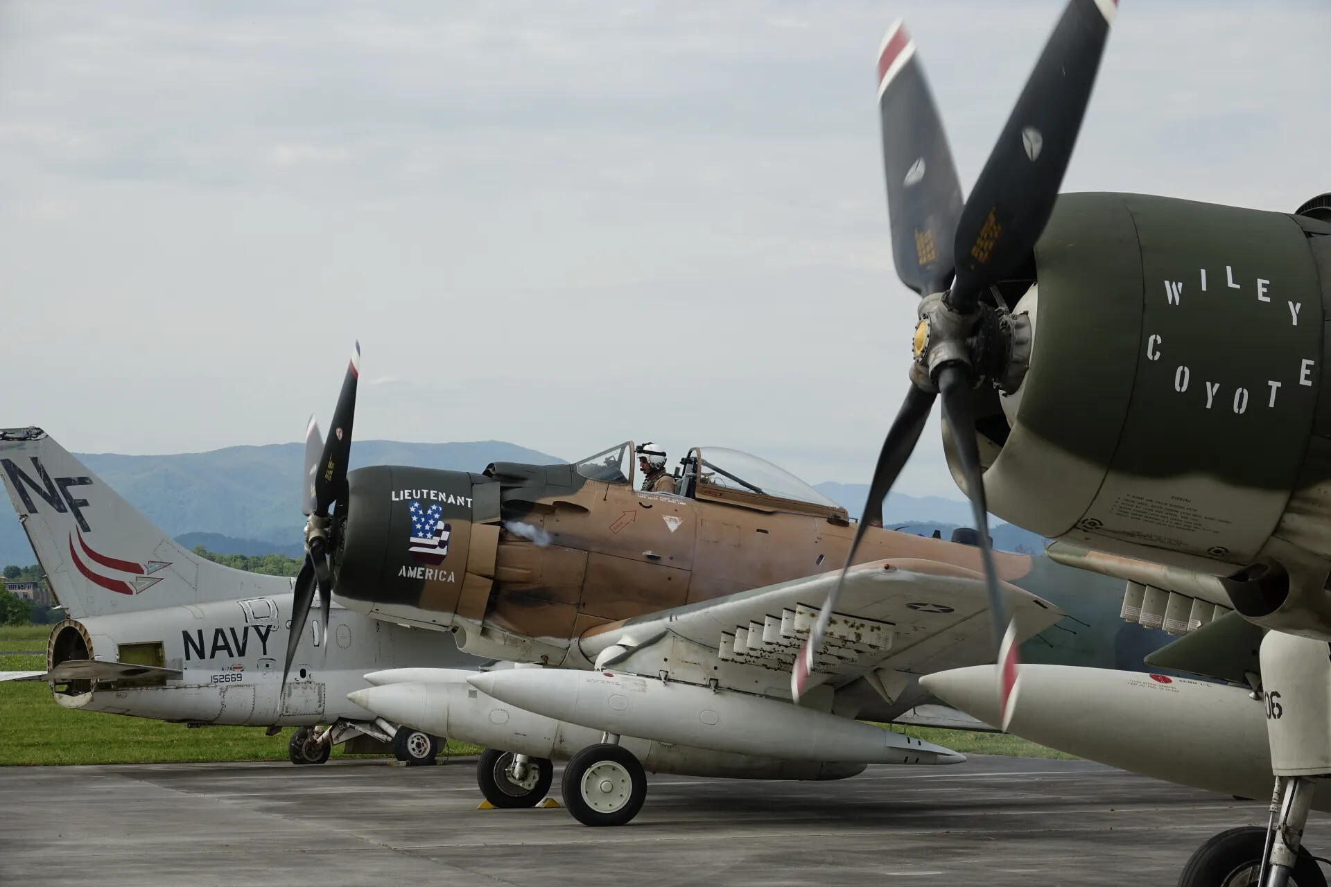 A-1 Skyraiders 'Wiley Coyote' and 'Lieutenant America' with A-7 Corsair II, Flight Line