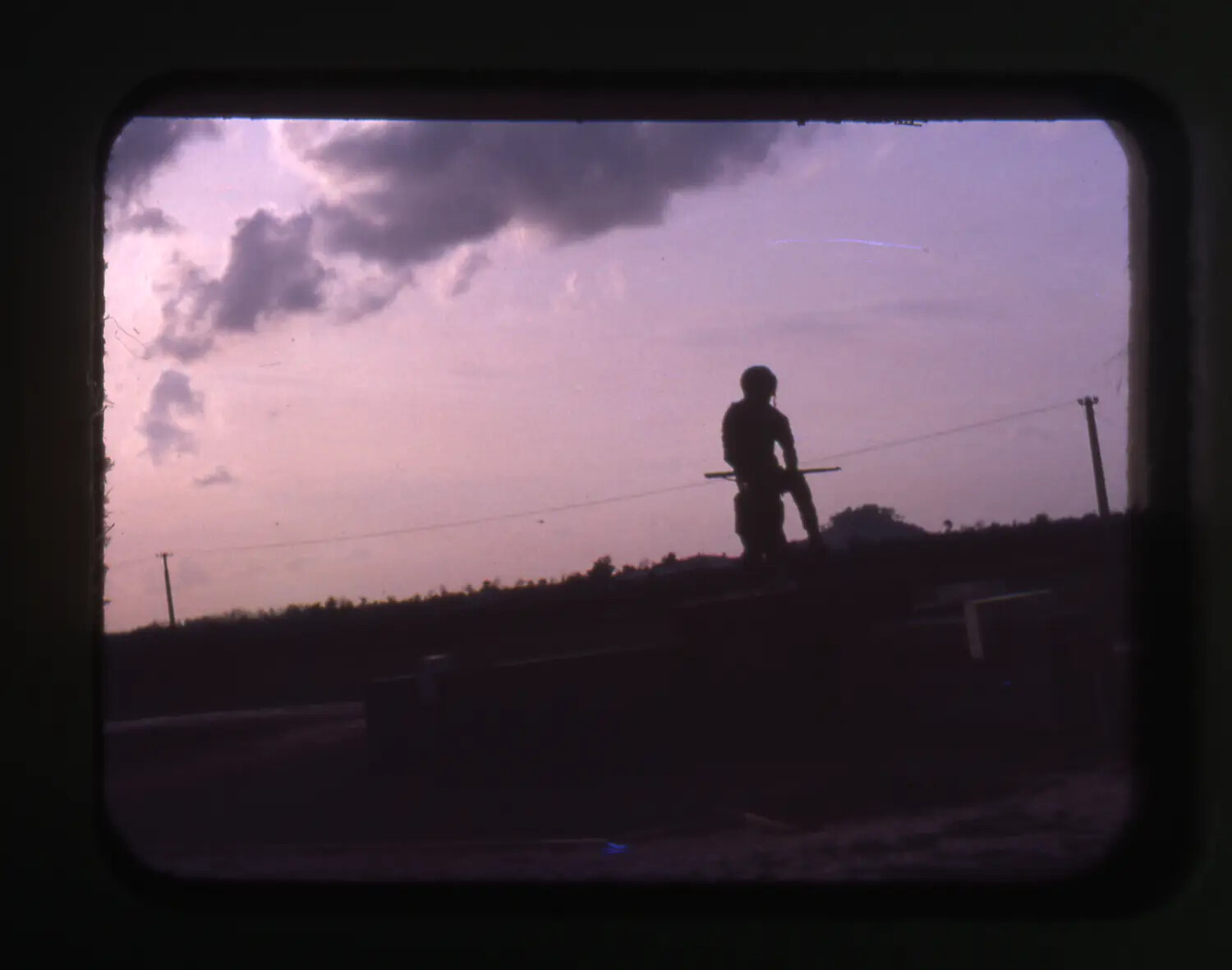 Silhouetted Sentry Atop a Bunker Line at Dusk, Vietnam (Cam Ranh Bay Vicinity)