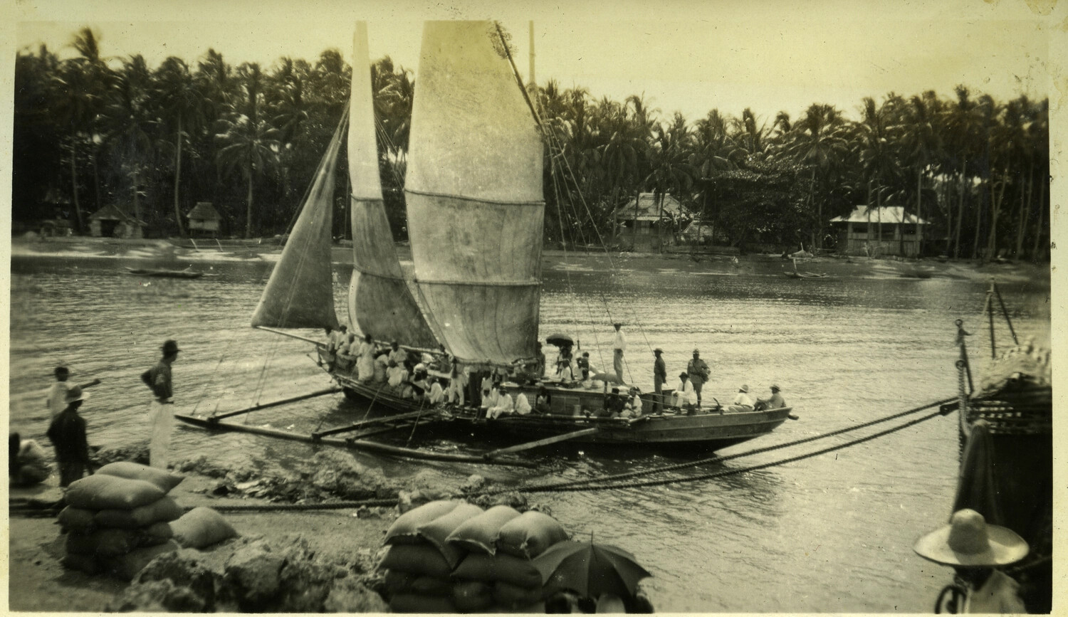 Outrigger Sailing Vessel Loaded with Passengers Near a Provincial Waterfront, Philippines, c. 1920s-1930s