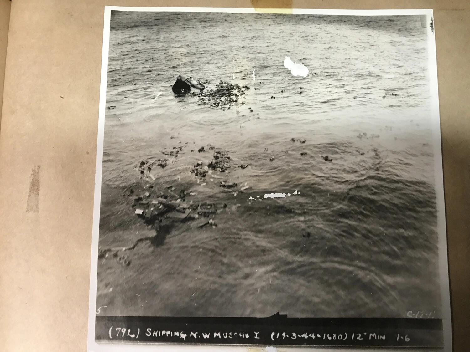 Official Strike Photograph No. 79L: Wreckage from Sunk Vessel, Shipping N.W. Muschu Island, 19 March 1944