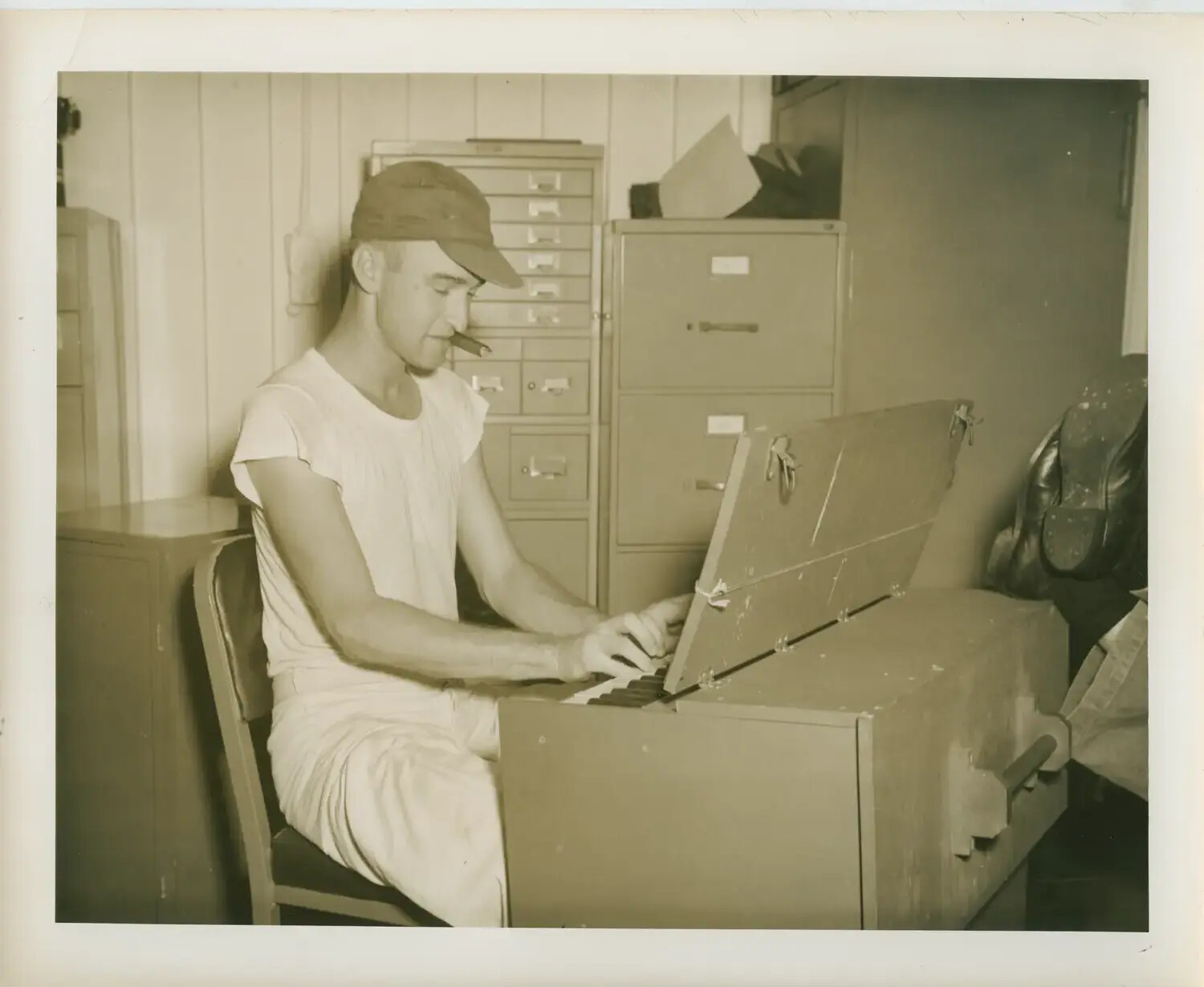 Sailor Playing a Portable Pump Organ Aboard USS Petrof Bay (CVE-80), WWII