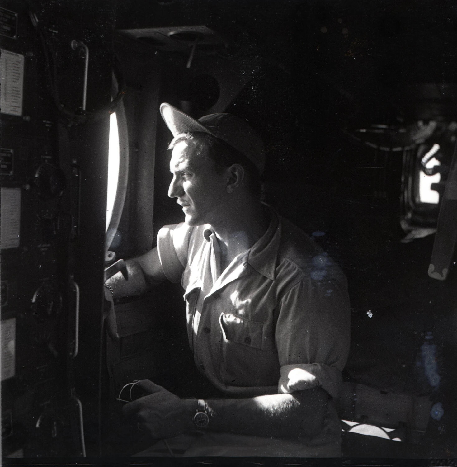 Airman Peering Through Aircraft Porthole, Interior of B-25 Fuselage