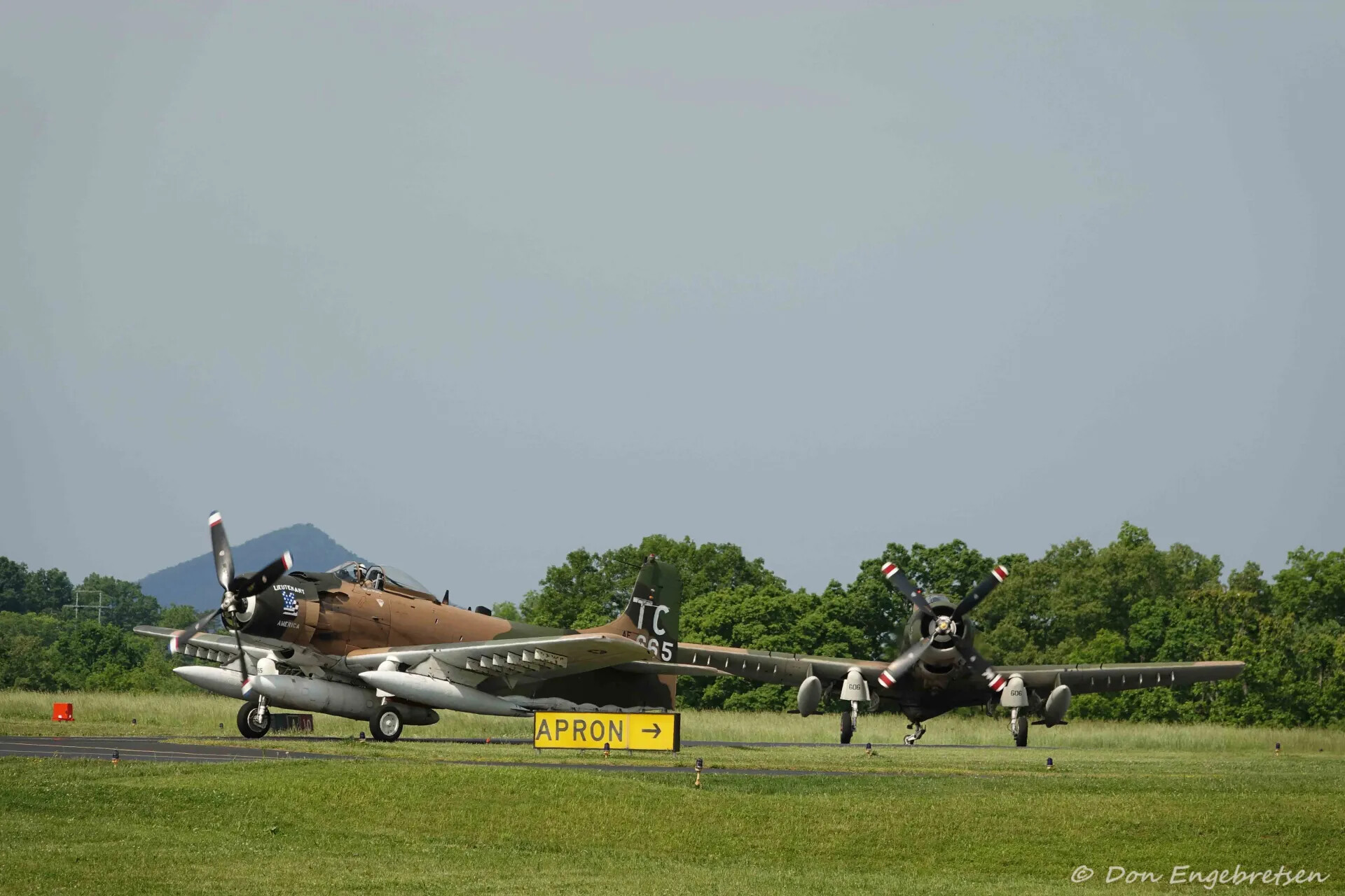 Two A-1 Skyraiders Taxiing Past APRON Sign, May 2019 Event