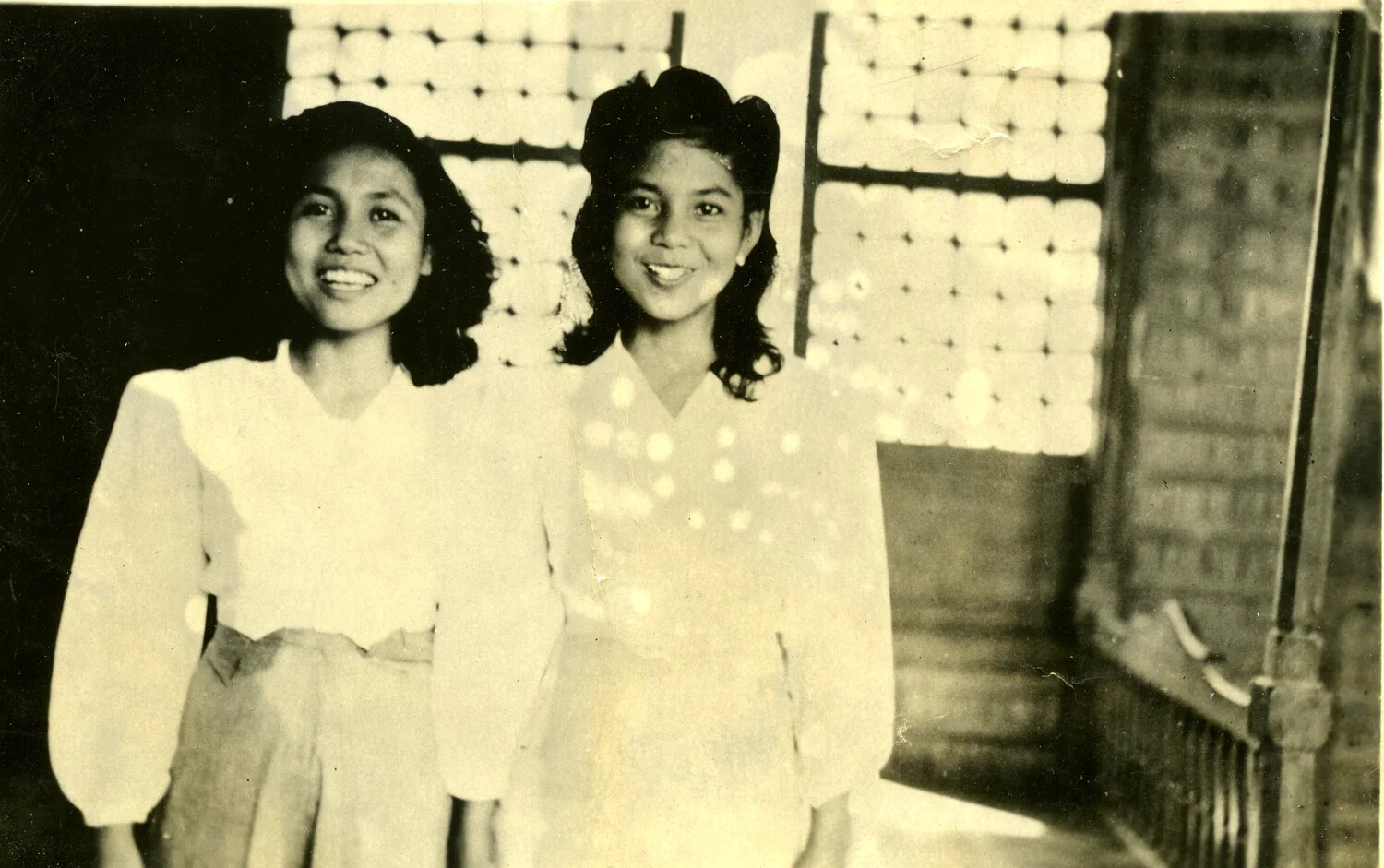 Portrait of Two Young Women on a Balcony with Capiz-Shell Window, Philippines, WWII Era