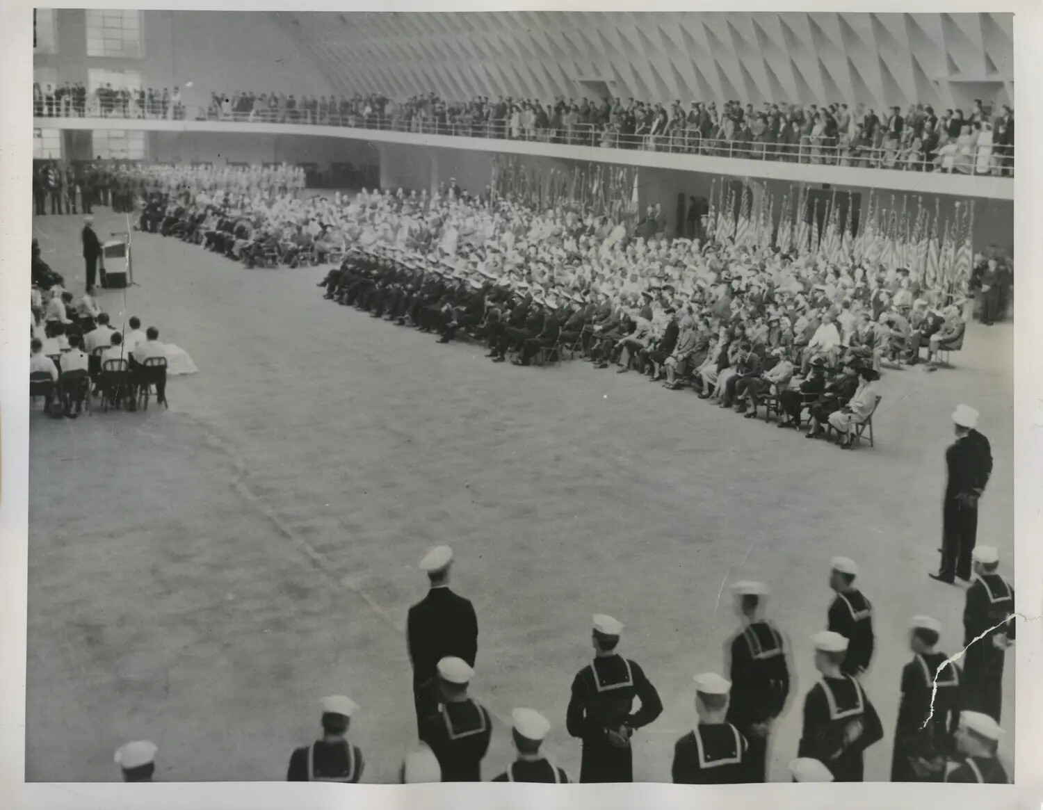 Navy Recruit Graduation Ceremony in Large Drill Hall with Packed Spectator Gallery