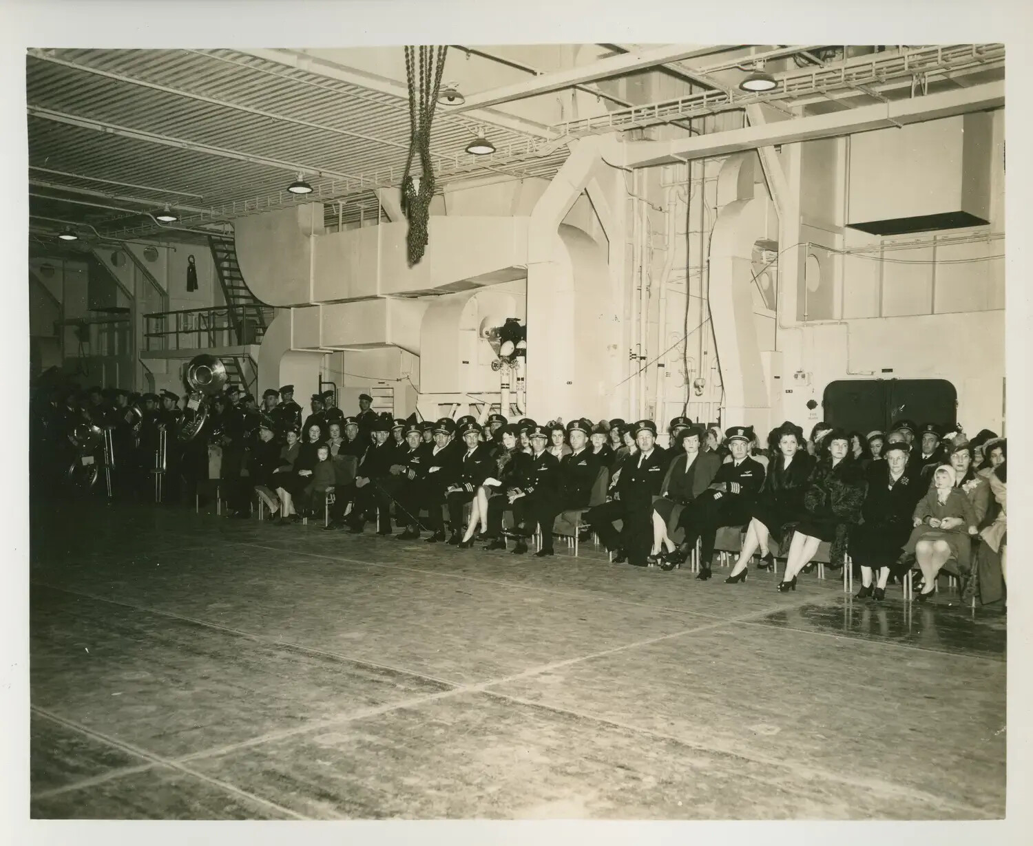 Commissioning Ceremony in Hangar Bay of Escort Carrier, Likely USS Petrof Bay (CVE-80)