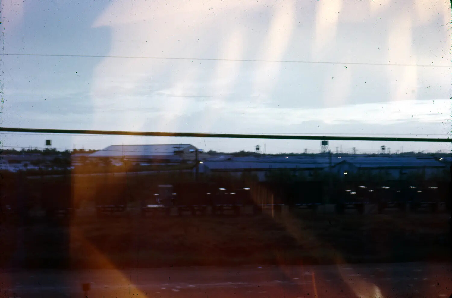 Twilight View of a Vietnam War-Era Military Base or Air Facility, Photographed Through Glass (35mm Slide, S. Sac Collection)