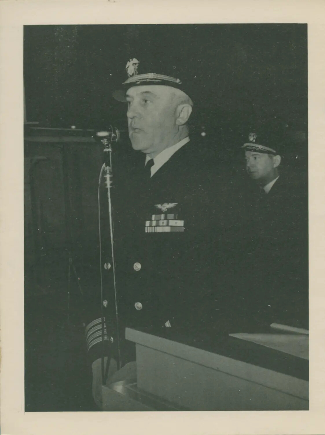 Naval Officer Addressing Audience at Podium, USS Petrof Bay (CVE-80) Collection