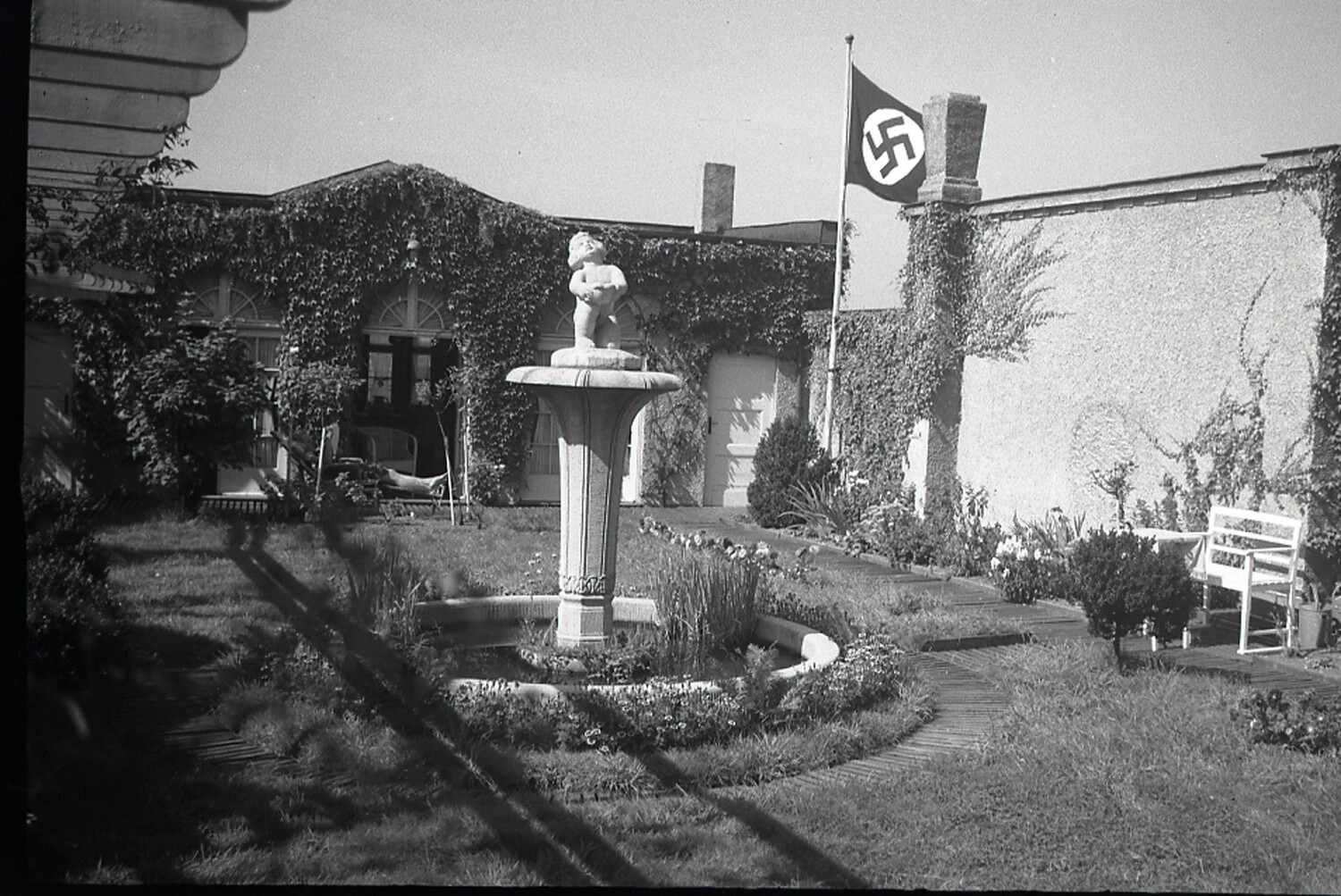 Garden Courtyard with Fountain and Swastika Flag at Requisitioned Villa, WWII Era