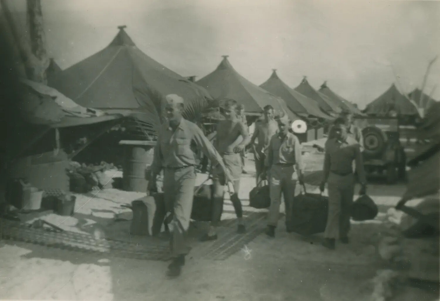 Servicemen Carrying Duffel Bags Through Tent Camp, Pacific Theater, WWII (McAleer Album)