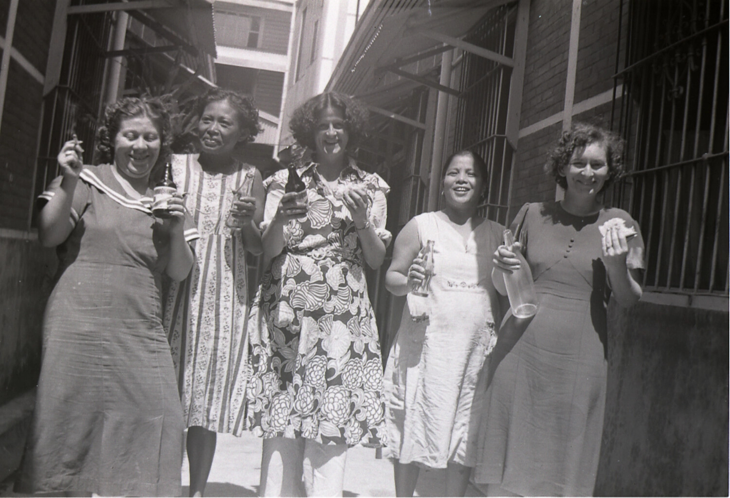 Five Women Sharing Refreshments in a City Alley